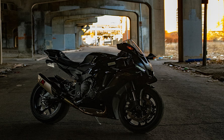 Black Yamaha YZF-R1 Sportbike Parked in Concrete Underpass at Golden Hour HD wallpaper