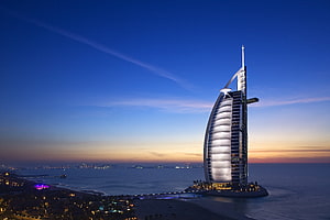 Burj Al Arab Hotel at Dusk in Dubai with Arabian Gulf and City Lights HD wallpaper