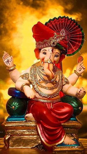 Ganesha Murti in Red Attire with Golden Ornaments and Fan Headdress HD phone wallpaper