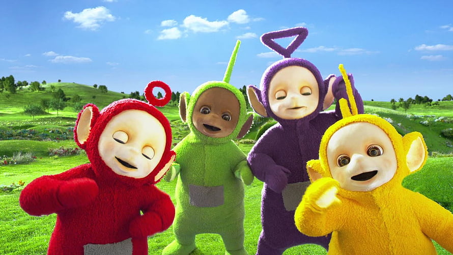Teletubbies Group Portrait in Vibrant Green Meadow Under Blue Sky HD wallpaper