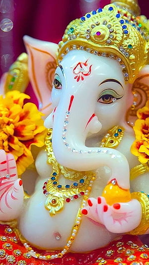 Adorned Ganesha Idol With Golden Crown And Marigold Flowers HD phone wallpaper