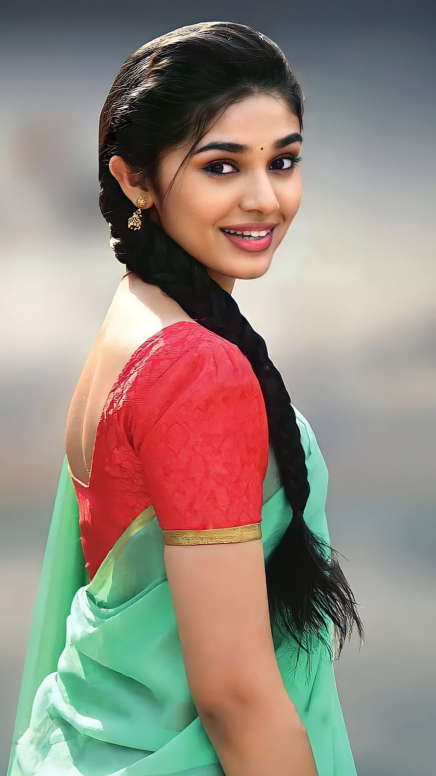 Krithi Shetty in a mint green saree with a red blouse and long braid HD phone wallpaper