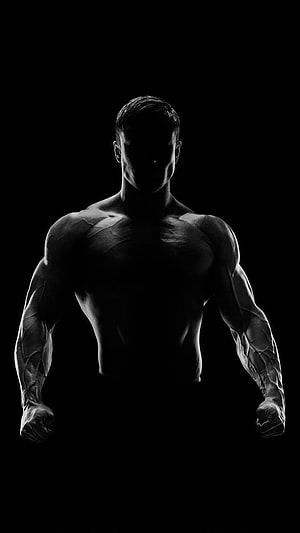 Dramatic Silhouette of a Muscular Male Athlete in Black and White HD phone wallpaper