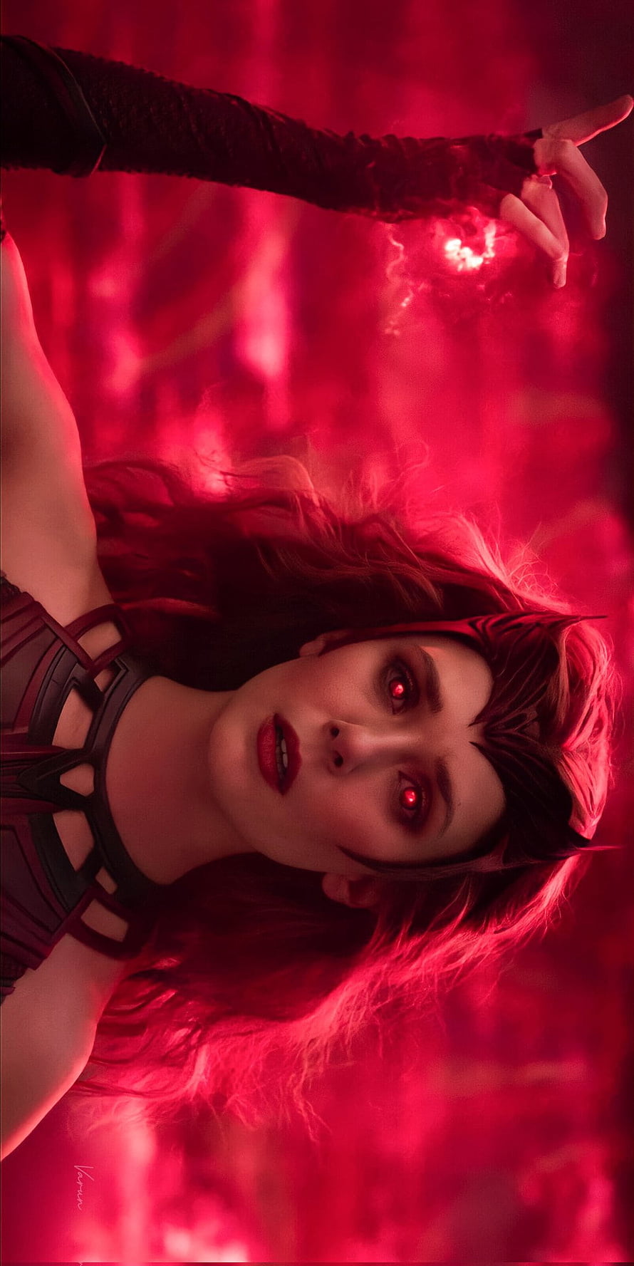 Elizabeth Olsen as Wanda Maximoff with glowing red eyes in a dramatic crimson-lit Marvel scene HD phone wallpaper