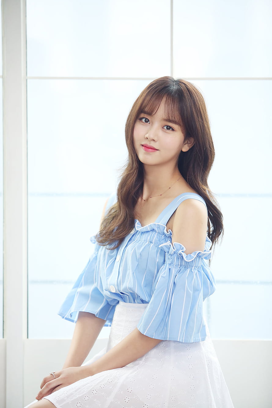Kim So Hyun in a Light Blue Striped Off-Shoulder Blouse and White Skirt HD phone wallpaper