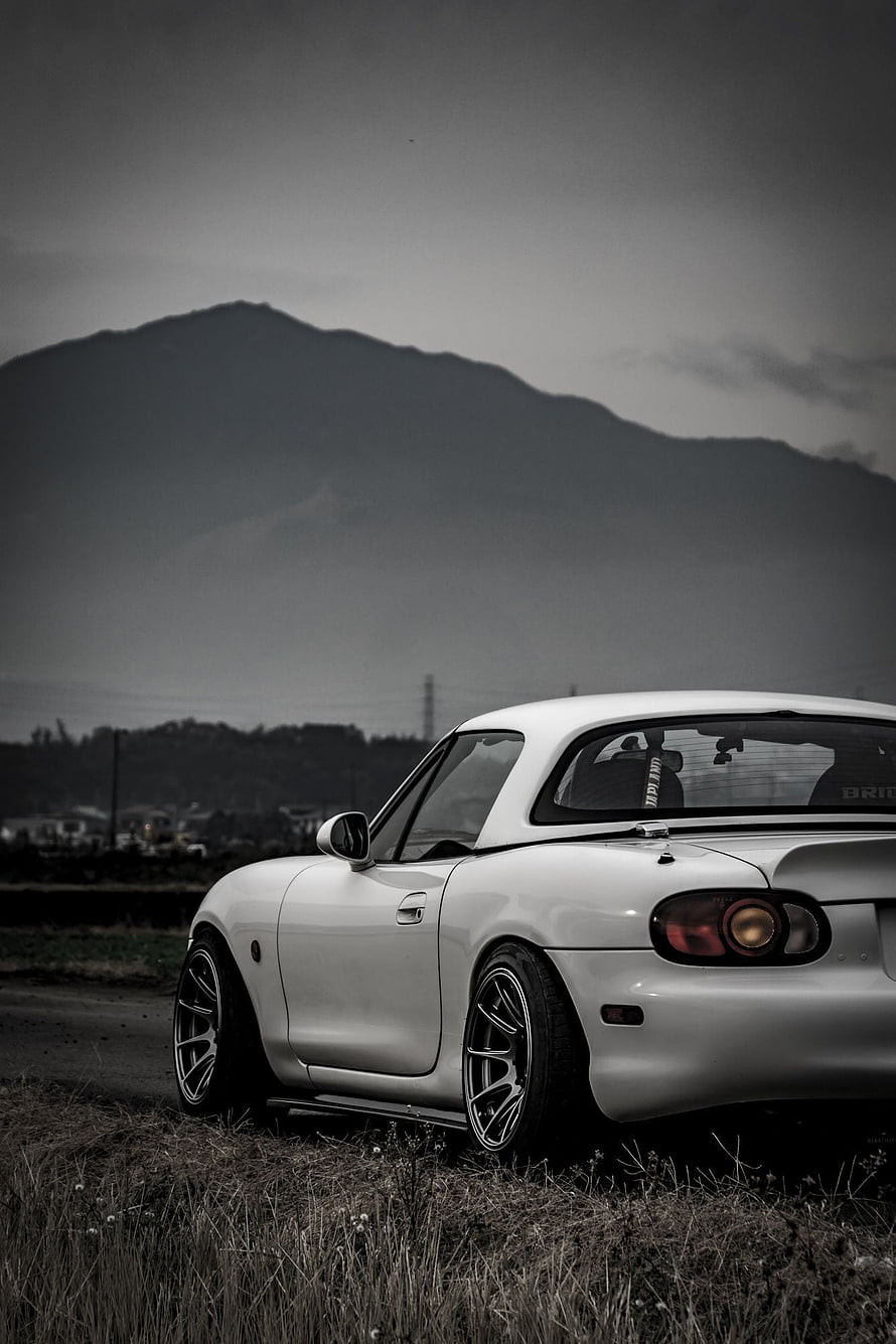 White Mazda Miata MX-5 Coupe Parked in a Field with Mountain Backdrop HD phone wallpaper