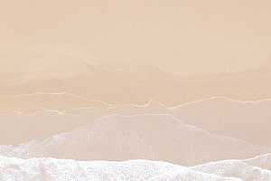 Minimalist beige mountain landscape with soft snow-capped peaks and hazy atmosphere HD wallpaper