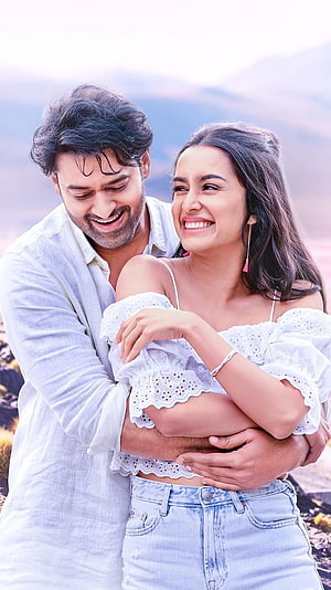 Prabhas and Female Co-Star Embracing in Romantic Outdoor Scene from Saaho HD phone wallpaper
