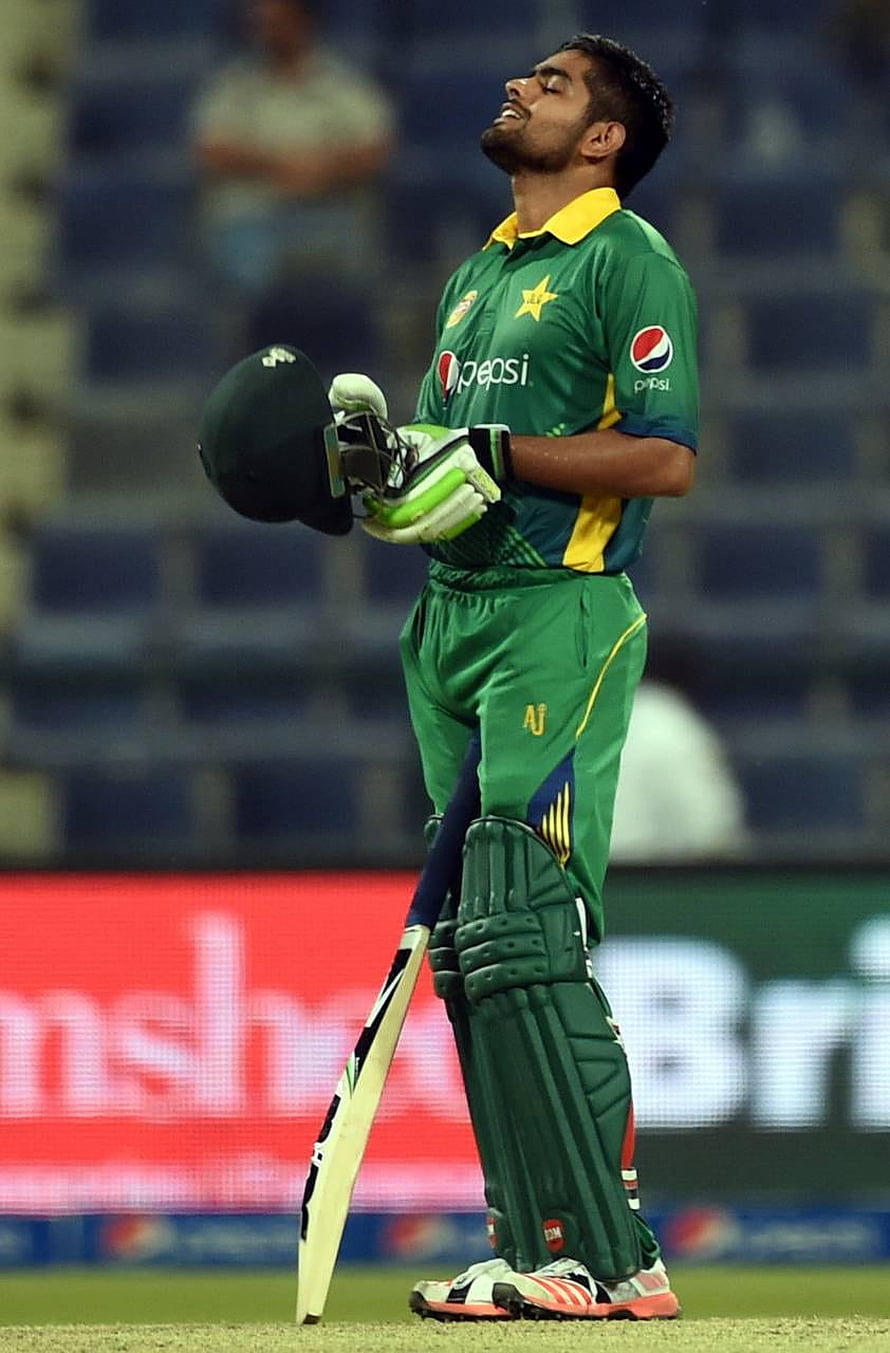 Babar Azam in Pakistan Cricket Team Green Kit Holding Bat and Helmet on the Field HD phone wallpaper