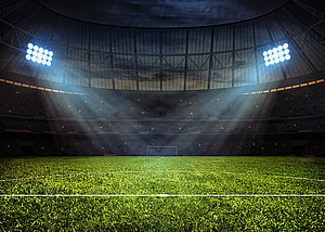 Dramatic Night Football Stadium With Bright Floodlights And Green Pitch HD wallpaper