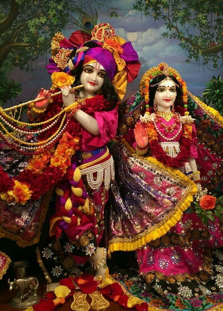 Radhe Krishna Divine Couple in Ornate Traditional Attire with Floral Garlands and Jewelry HD phone wallpaper