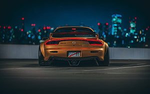 Rear View of a Gold Mazda RX-7 on a Night Highway with City Bokeh Lights HD wallpaper