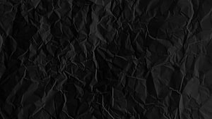 Dark Crumpled Paper Texture Background with Deep Folds and Rugged Surface Detail HD wallpaper