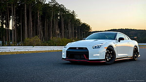White Nissan GT-R R35 with Body Kit on a Forest Track at Sunset HD wallpaper