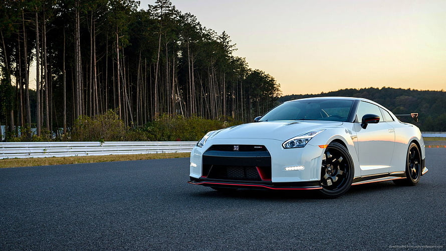 White Nissan GT-R R35 with Body Kit on a Forest Track at Sunset HD wallpaper
