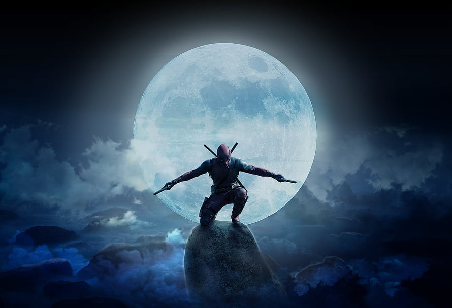 Deadpool standing on a rock with dual pistols against a massive full moon in a dark cloudy night sky HD wallpaper