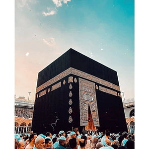 The Sacred Kaaba in Makkah Surrounded by Pilgrims During Hajj Under a Clear Sky HD phone wallpaper