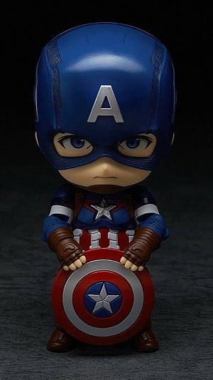 Chibi Captain America Figure Holding Shield in Dark Studio Setting HD phone wallpaper