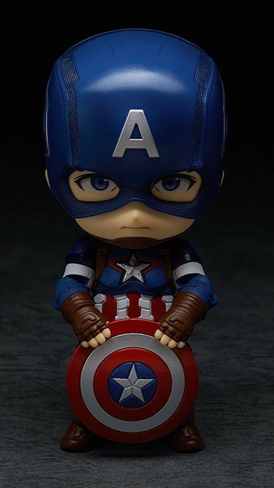 Chibi Captain America Figure Holding Shield in Dark Studio Setting HD phone wallpaper