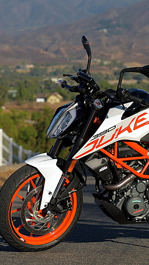KTM 390 Duke Motorcycle in White and Orange Parked on a Scenic Mountain Road HD phone wallpaper