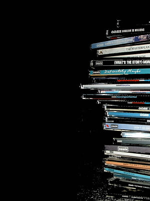 Oasis Band CD Collection Spine Display on Black Background HD phone wallpaper