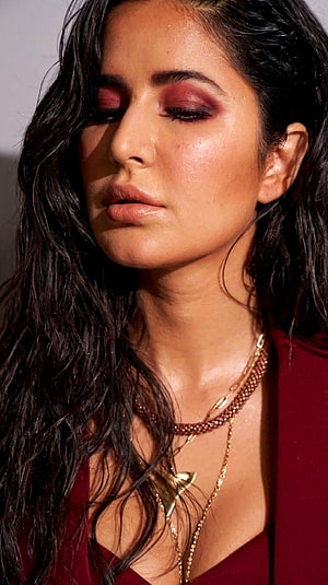 Katrina Kaif in a deep red ensemble with layered gold necklaces and dramatic smoky eye makeup HD phone wallpaper
