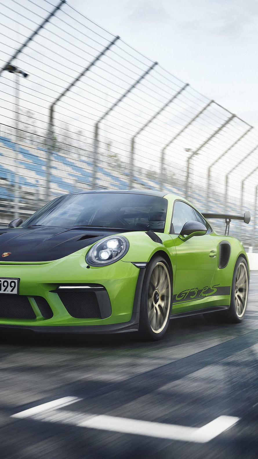 Lime Green Porsche 911 GT3 RS Racing on a Track with Motion Blur and Grandstand Background HD phone wallpaper