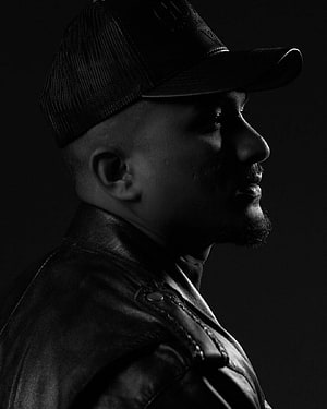 Divine Rapper in Black Leather Jacket and Cap, Dramatic Low-Key Profile Portrait HD phone wallpaper