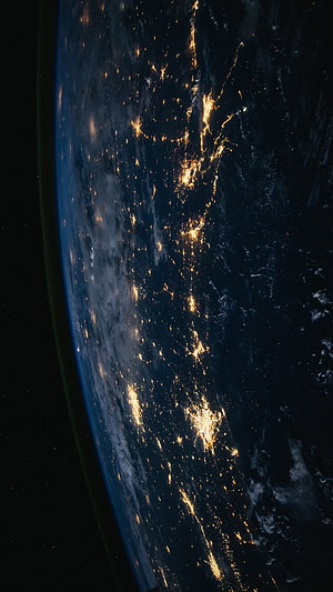 Earth at Night from Space with City Lights and Atmospheric Glow HD phone wallpaper
