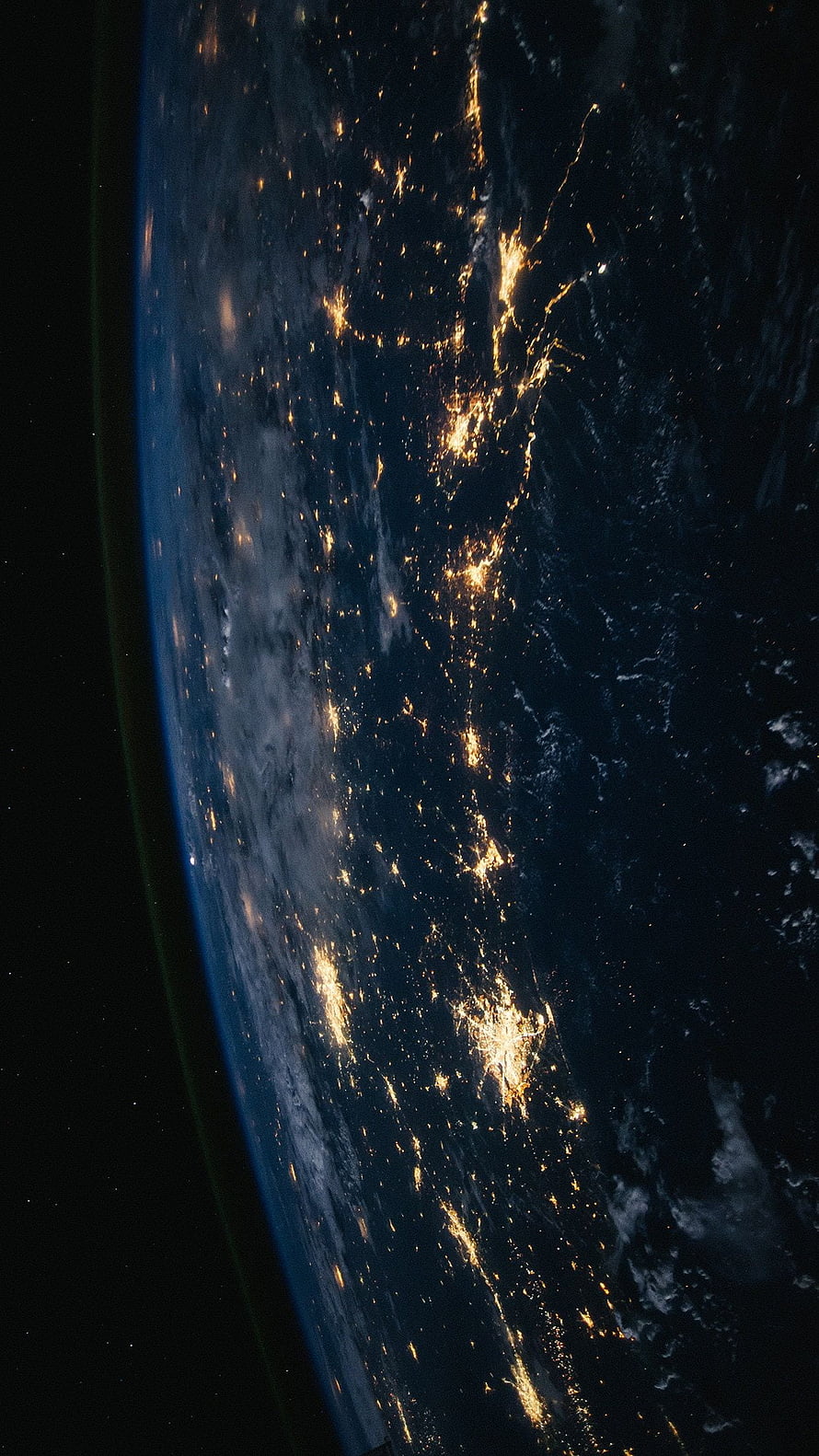 Earth at Night from Space with City Lights and Atmospheric Glow HD phone wallpaper