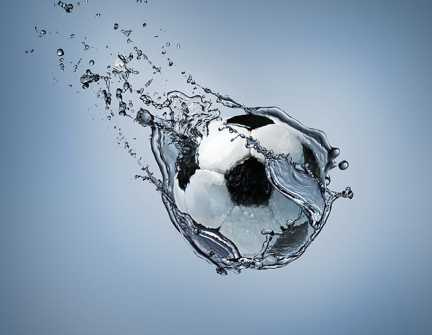 Dynamic Soccer Ball Captured in Mid-Air with Dramatic Water Splash Effect HD wallpaper
