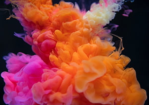 Vibrant Pink and Orange Ink Clouds Billowing in Dark Water HD wallpaper