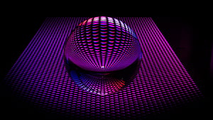 Glowing LED Sphere on a Grid of Purple and Pink Lights in a Dark Setting HD wallpaper