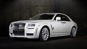 White Mansory Rolls Royce Phantom luxury sedan in dark studio setting HD wallpaper