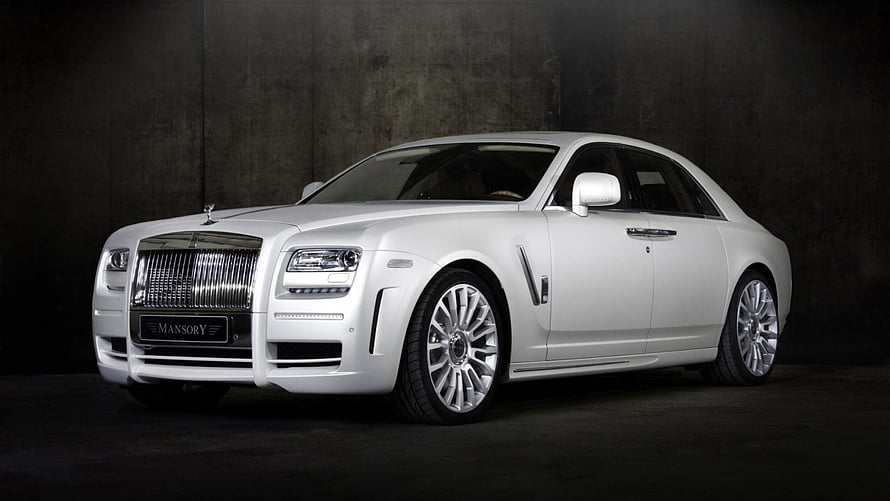 White Mansory Rolls Royce Phantom luxury sedan in dark studio setting HD wallpaper