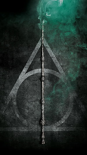 Harry Potter Deathly Hallows Symbol with Ornate Wand and Green Smoke on Dark Textured Background HD phone wallpaper