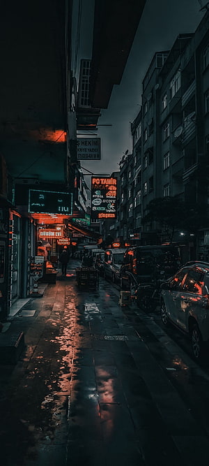 Moody Wet Street Scene with Neon Signs and Parked Cars at Dusk HD phone wallpaper