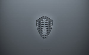 Koenigsegg Shield Emblem on Textured Gray Surface HD wallpaper