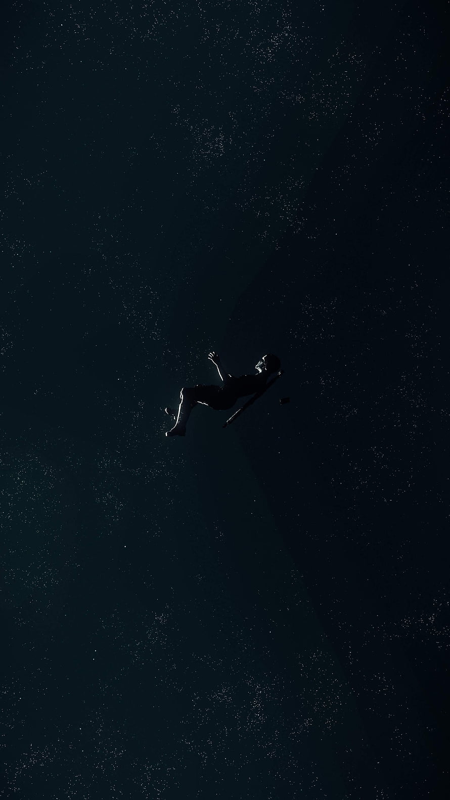Silhouette of a Falling Astronaut Drifting Through the Vast Darkness of Deep Space HD phone wallpaper