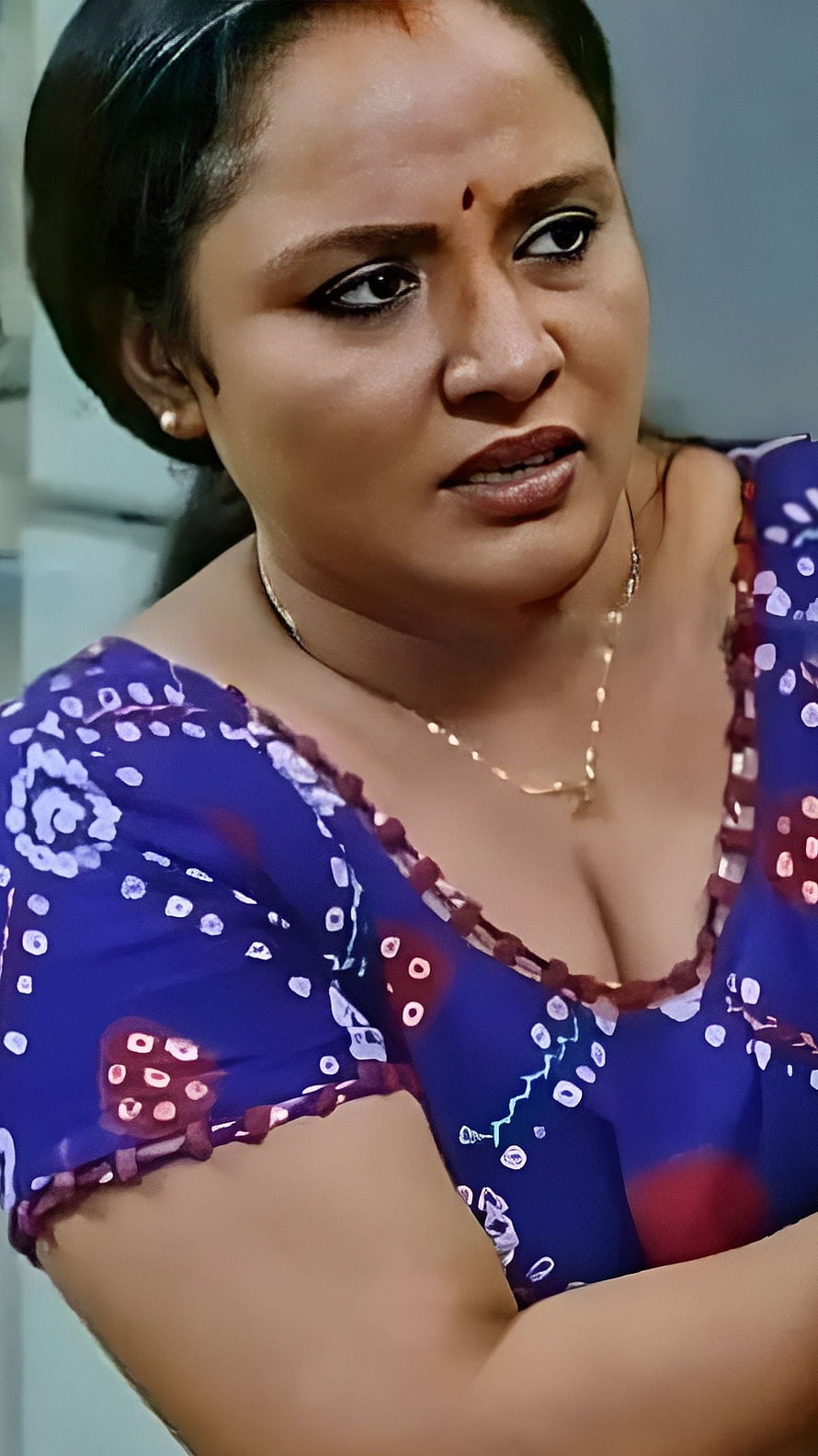 Nisha Sarang in a blue patterned blouse with a concerned expression HD phone wallpaper