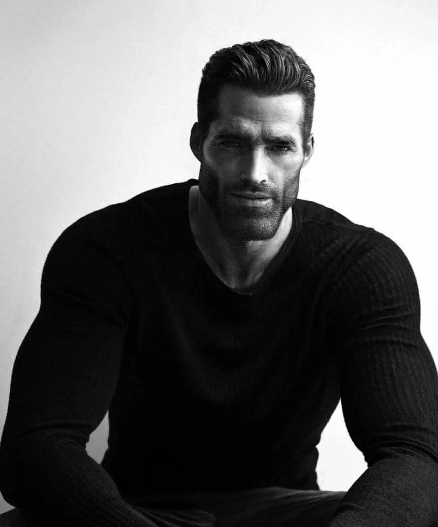 Black and white studio portrait of a muscular man with a beard wearing a dark long-sleeve shirt HD phone wallpaper