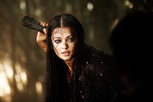Raavanan Movie Still Featuring Intense Female Warrior in Dark Forest Setting HD wallpaper