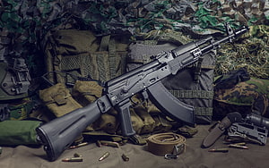 AK-74 assault rifle displayed with tactical gear, camouflage netting, and loose ammunition HD wallpaper
