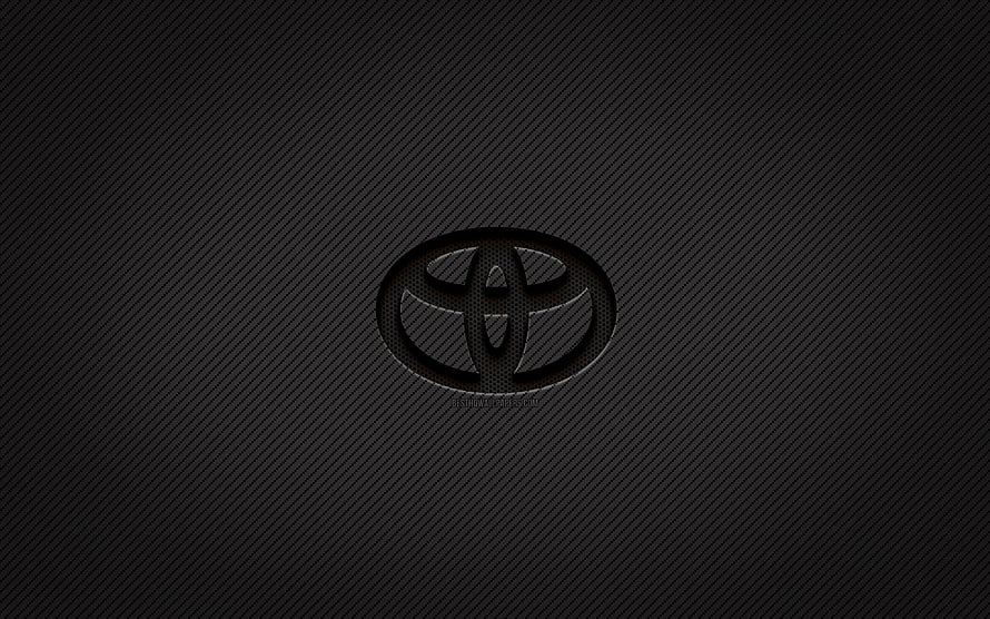 Toyota emblem on dark carbon fiber texture with subtle diagonal weave pattern HD wallpaper