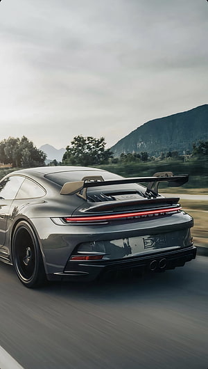Porsche 911 GT3 RS Rear View on Mountain Road with Large Rear Wing and Motion Blur HD phone wallpaper