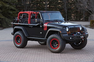 Black Jeep Wrangler Unlimited with Red Accents and Off-Road Tires HD wallpaper