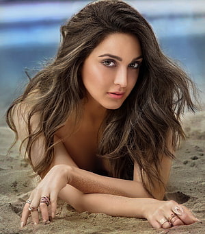 Kiara Advani Beach Portrait with Long Wavy Hair and Sand Textures HD phone wallpaper