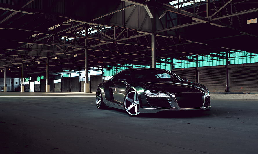 Audi R8 sports car parked in a dark industrial warehouse with teal window light HD wallpaper