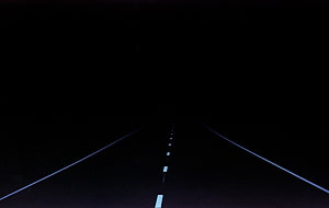 Minimalist Dark Highway Stretching Into the Night With Faint Road Markings HD wallpaper
