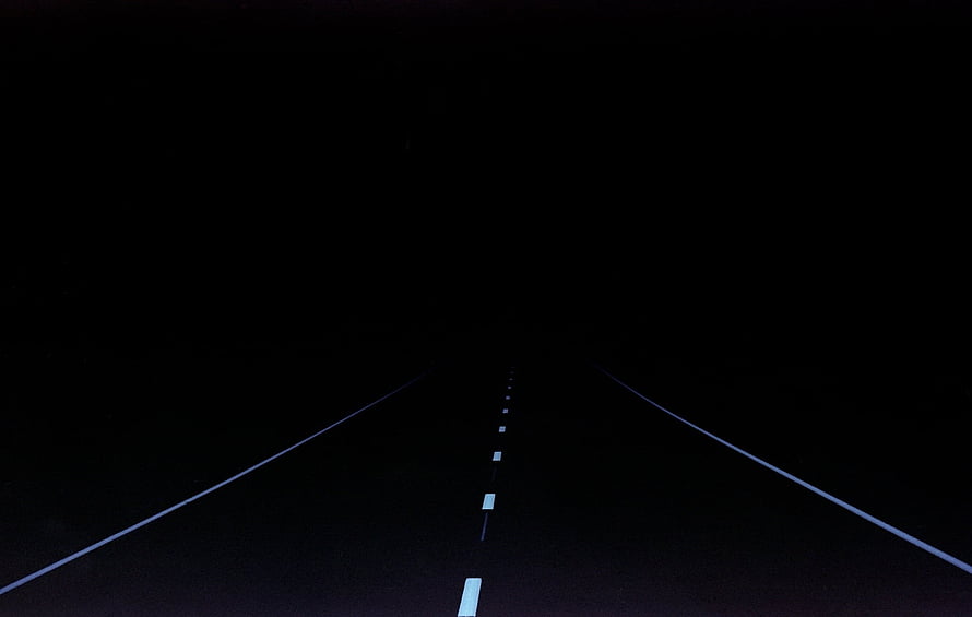 Minimalist Dark Highway Stretching Into the Night With Faint Road Markings HD wallpaper